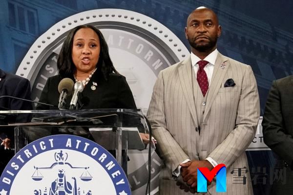 Fulton County District Attorney Fani Willis speaks at a press co<em></em>nference next to prosecutor Nathan Wade