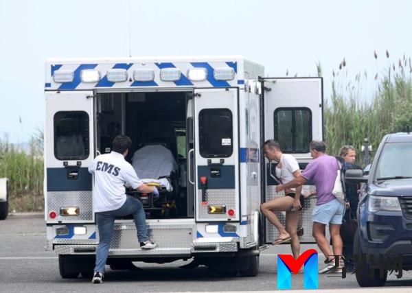 A shark bite victim being brought into an ambulance in Great Rriver, New York after being transported by police from Fire Island Pines on July 4, 2023.