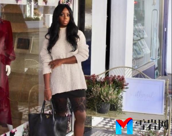 Venetia Williams pictured wearing a cream jumper and a lace skirt, she is wearing a long black wig