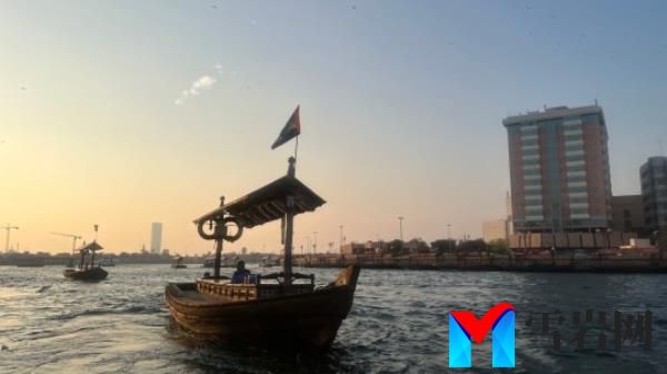 An abra at sunset crossing Dubai Cree