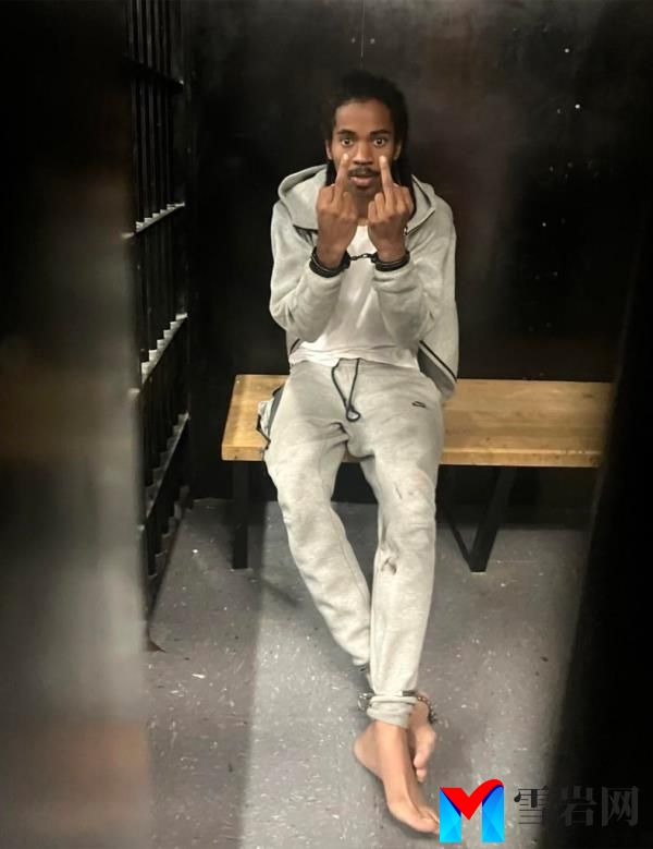 Joshua Dorsett, 22,  in his holding cell giving the middle finger with both hands while handcuffed and shackled