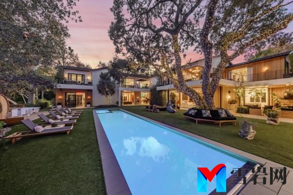 A pool and lounging area in the backyard.