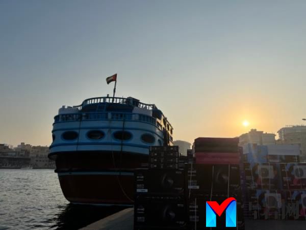 Dubai Creek is a bustling working harbour, busy with boats including traditio<em></em>nal wooden dhow - Emerati cargo ships, pictured here loading up with white goods