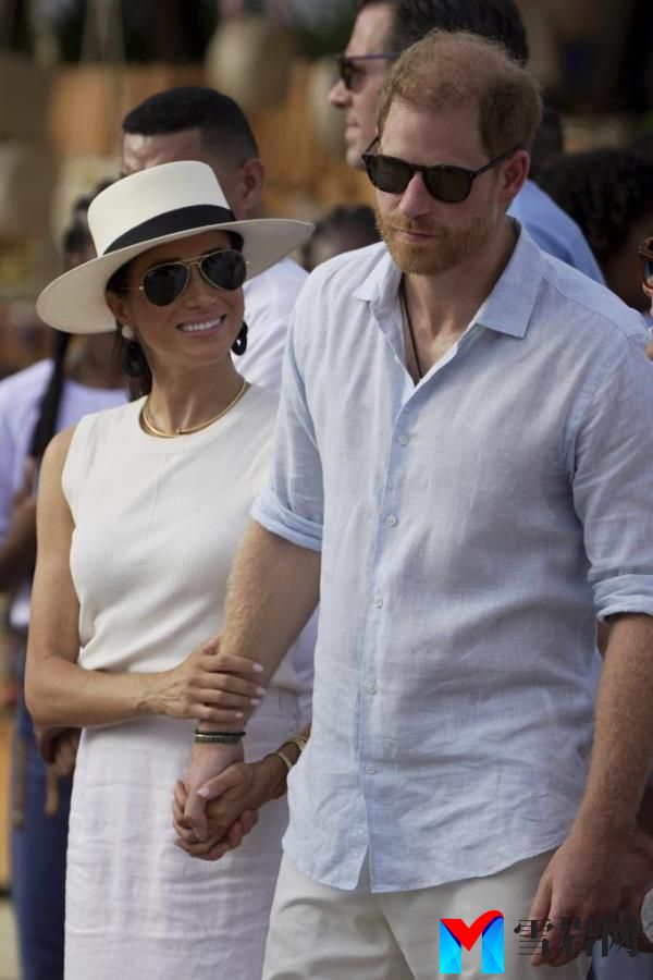 Prince Harry and Meghan Markle arriving in San Basilio de Palenque, Colombia, holding hands