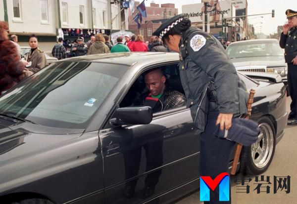 Michael Jordan signs an autograph for a Chicago Police officer outside Wrigley Field on opening day, April 4, 1993 in Chicago, Illinois. 