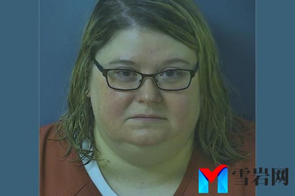 Mugshot of Heather Pressdee, wearing glasses and orange clothes.