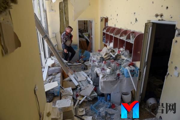 A Ukrainian man inspecting a building destroyed by Russian shelling in Do<em></em>netsk on May 11, 2024.