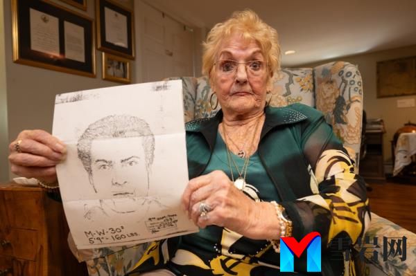 Savino holding her sketch of her shooter.