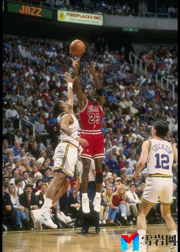 Guard Michael Jordan of the Chicago Bulls (center) shoots the ball during a game against the Utah Jazz at the Delta Center in Salt Lake City, Utah in 1993. 