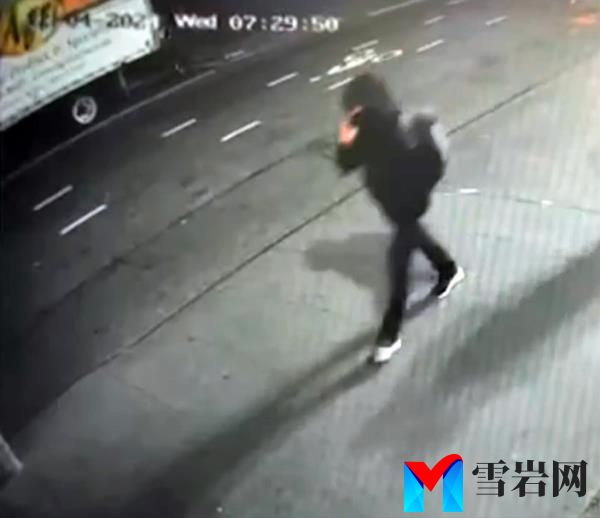The suspect, wearing a black jacket, hat, ski mask, and gray backpack, was seen talking on the phone while walking East on 54th Street around 6:30 a.m.