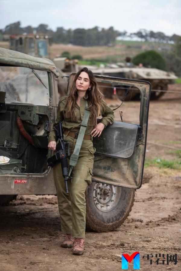 Miss Israel, Noa Cochva, in military uniform standing next to a vehicle, a former IDF battlefield medic and paramedic course commander