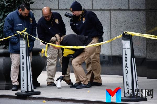 Members of the New York police crime scene unit pick up cups marking the spots wher<em></em>e bullets lie as they investigate the scene outside the Hilton Hotel in midtown Manhattan wher<em></em>e Brian Thompson, the CEO of UnitedHealthcare, was fatally shot