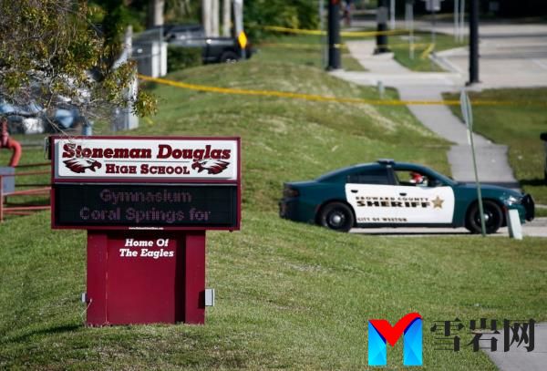Law enforcement officers block off the entrance to Marjory Sto<em></em>neman Douglas High School Feb. 15, 2018 in Parkland, Fla., following a deadly shooting at the school.