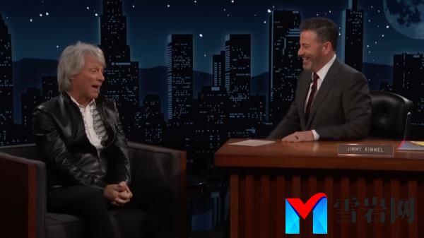 Jon Bon Jovi and Jimmy Kimmel sitting at a podium, discussing a past event wher<em></em>e Bon Jovi partied with Michael Jackson’s chimp, Bubbles
