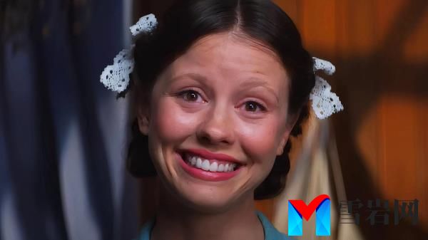 Peal (Mia Goth) smiling intensely and awkwardly into the camera at the end of Ti West