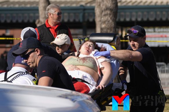 A person is taken to an ambulance after an incident following the Kansas City Chiefs victory parade in Kansas City.