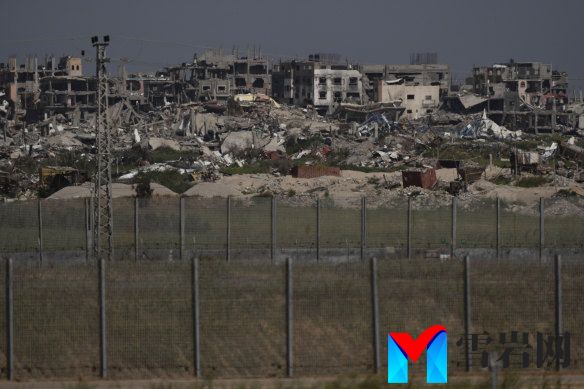 Destroyed buildings stand in the Gaza Strip as seen from southern Israel on Thursday.