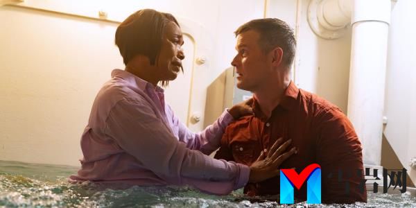 Angela Bassett as Athena Grant-Nash and Peter Krause as Bobby Nash holding each other in a flooding room in 9-1-1 season 7.
